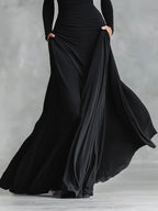 Adele - Modern long black crepe dress with boat neck and pleats