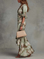 Anna | Asymmetrical long dress in green satin with V-neck, flared puff sleeves, and floral pattern